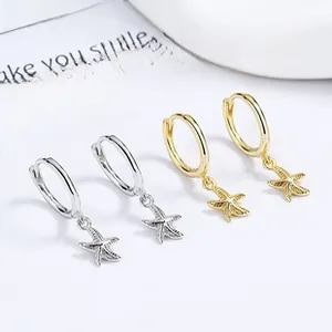 Macro view of sterling silver starfish hoop earrings in gold and silver finishes