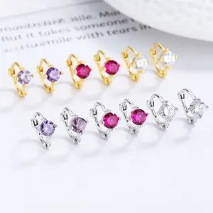 Detail of 925 sterling silver hoop earrings set with purple and red cubic zirconia