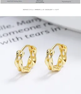 Macro shot of 925 sterling silver golden twisted hoop earrings with hypoallergenic finish