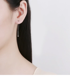 Close-up of 925 sterling silver threader earrings with sleek beads and tassel chain