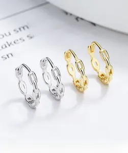 Detail of 925 silver and gold chain link hoop earrings with high polish finish