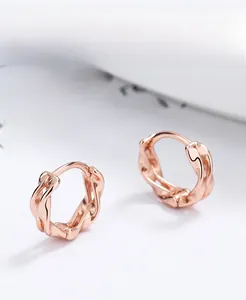 Detail of rose gold S925 sterling silver Mobius earrings with twisted rope texture
