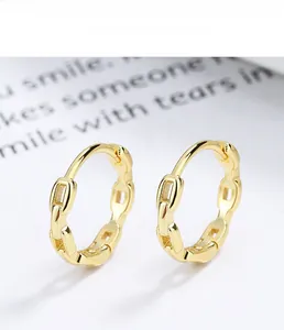 Detail of gold s925 sterling silver hoop earrings with hollow chain link texture