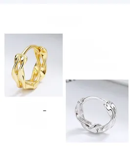 Close-up of 925 sterling silver Mobius earrings in gold and silver finishes