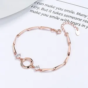 Detail of rose gold daisy bracelet featuring sparkling rhinestones and bamboo link chain
