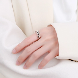 Polished 925 sterling silver croissant twist ring worn by model in minimalist style