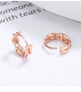 Macro detail of rose gold 925 silver earrings with S925 hallmark and twisted texture