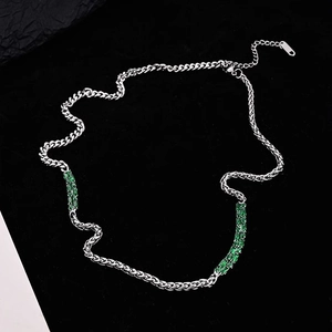 Close-up of Cuban link necklace with emerald green rectangular zirconia stones