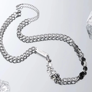 Detailed macro of titanium steel Cuban chain with marble beads and FOREVER engraving