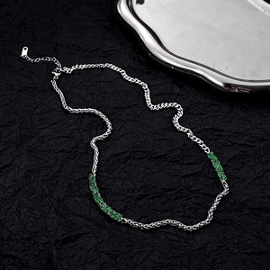Detail of silver splice chain necklace with rectangular emerald green zircon stones