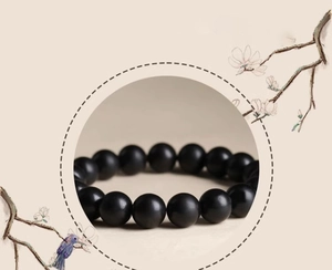 Macro detail of men's matte black wooden beads bracelet with 12mm minimalist design
