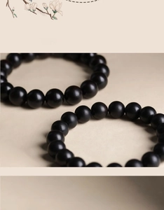 Detailed close-up of premium black wooden beads with matte texture and minimalist design
