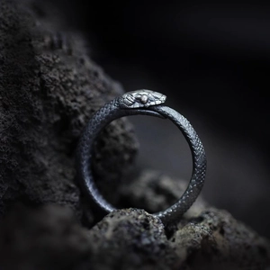 Vintage Ouroboros adjustable ring with detailed scales on textured black stone
