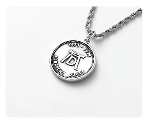 Detailed close-up of vintage coin pendant with Albrecht Durer monogram and braided chain