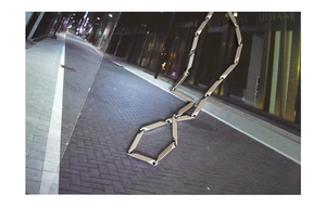 Detail of silver titanium steel necklace with geometric rectangular cut-out links