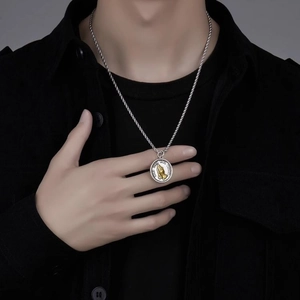 Men's retro praying hands pendant necklace in silver and gold finish on black shirt
