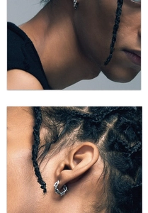 Macro detail of silver punk barbed wire earrings showcasing sharp textured craftsmanship