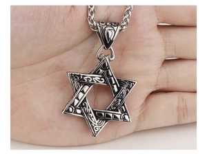 Gros plan d'un collier pendentif hexagramme vintage avec texture relief baroque