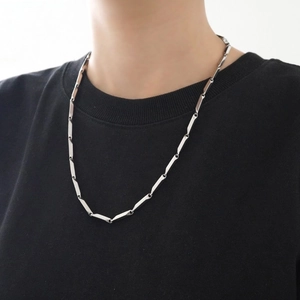 Minimalist silver rhombus titanium steel chain necklace worn on a black t-shirt