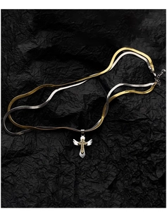 Close-up of two-tone cross pendant with angel wings on gold and silver snake chains