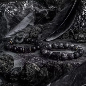 Handmade volcanic stone and matte onyx bead bracelets set with mysterious smoke background