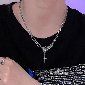 Detail of moonstone cross necklace with asymmetric chain and gothic star pendant
