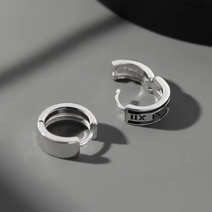 Macro view of S925 sterling silver hoop earrings with engraved Roman numerals