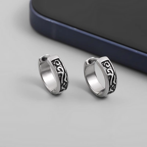 Retro silver hoop earrings for men with black enamel scroll patterns on smooth surface