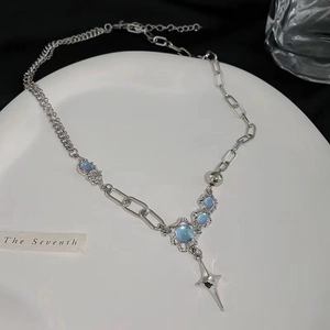 Asymmetric silver chain necklace with blue moonstones and a sharp star pendant
