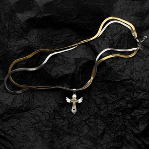 Two-tone snake chain necklace with winged cross pendant featuring sparkling stones