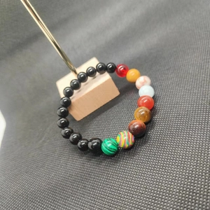 Solar system galaxy bracelet featuring colorful natural stone beads on a black background