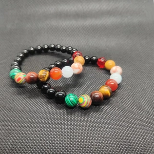 Detail view of solar system galaxy beads bracelet featuring tiger eye and obsidian stones