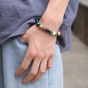 Close-up of lifestyle model wearing multi-color natural stone bead solar system bracelet