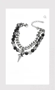 Detail of multi-layer bracelet with star pendant, black beads and crystal chain