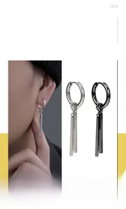 Detail view of silver and black stainless steel bar drop earrings on model and display