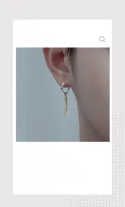 Detail shot of minimalist silver stainless steel earrings with double bar dangles on ear