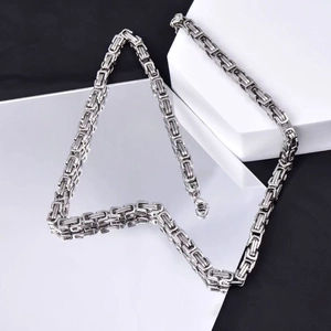 Silver stainless steel Byzantine chain necklace with lobster clasp on luxury background
