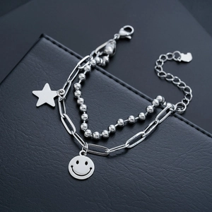 Double-layered stainless steel bracelet with star and smiley face charms on leather