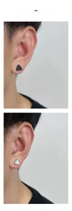 Close-up of black and silver textured triangle clip-on earrings on male model ear