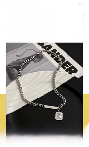 Detail of titanium steel cuban chain necklace with engravable bar and zircon pendant