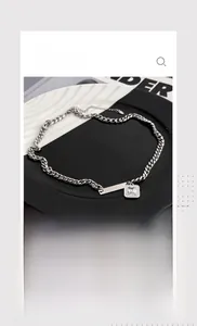Detail of silver titanium steel necklace featuring square zircon pendant and chain links