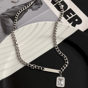Men's silver Cuban link necklace with zircon pendant on a fashion magazine background