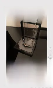 Silver bead necklace with engraved cylindrical pendant in a black 3D floating display frame