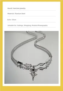 Detail of silver titanium steel necklace with black and clear zircons on a reflective surface