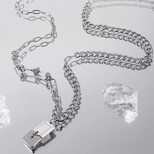 Macro shot of industrial style stainless steel chain necklace with rectangle lock pendant