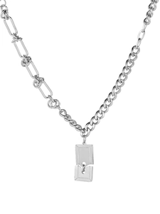 Close-up of asymmetric titanium steel chain with double geometric square pendants