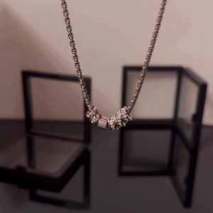Minimalist silver titanium necklace with five interlinked rings and sparkling crystals