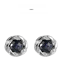 Detail of round starburst stud earrings with blue sandstone and crystal embellishment