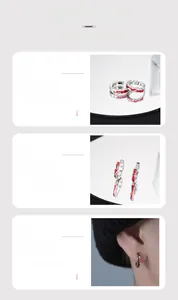 Detailed view of silver hoop earrings featuring irregular red enamel wave patterns