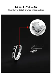 Macro detail of S925 sterling silver hoop earring with black enamel and star pattern